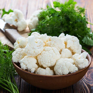 Fresh cauliflower florets in a wooden bowl with herbs, plant-based ingredients from WELAZA UAE