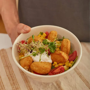 Plant-based nuggets salad bowl with corn, tomatoes, sprouts, and vegan sauce from WELAZA UAE